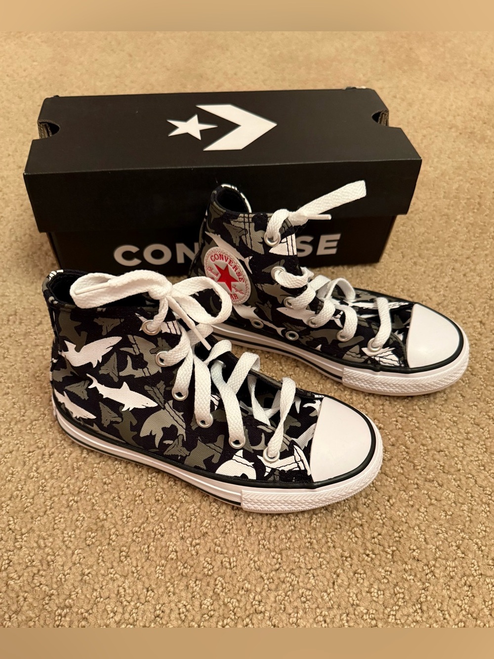 New in box. Converse high shark print sneakers. Size 11 ‘junior’.